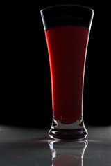 a glass of red wine on a dark background 