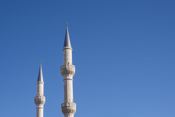 Fototapeta na wymiar Mosque Minarets and Clean Blue Sky