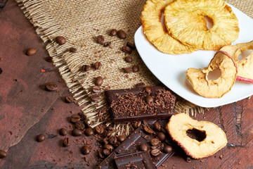 Dried fruits, apple, bananas, coffee and chocolate for breakfast