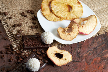 Dried fruits, apple, bananas, coffee and chocolate for breakfast