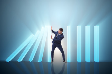 Fototapeta premium Businessman in domino effect business concept