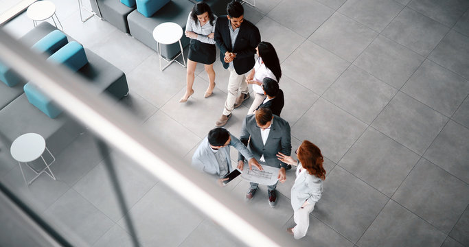 Corporate teamworking colleagues in modern office - Powered by Adobe