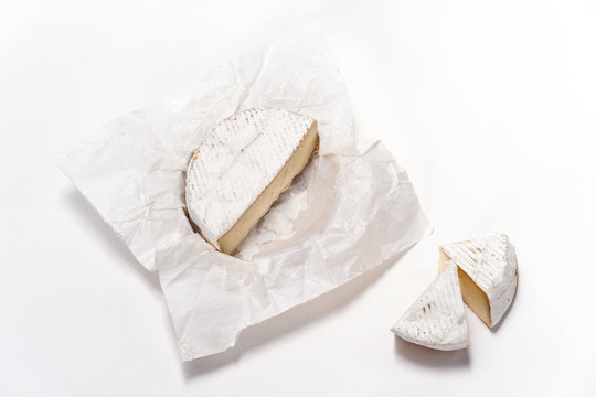 Cheese camembert or brie sliced on white background. Menu design restaurant. Top view design photo. Cheese in white paper.