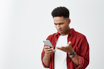 Close up portrait of young good-looking tan-skinned man with afro haircut in casual white t-shirt...