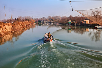 Ravenna, Emilia Romagna, Italy: landscape of the Po Delta Park, with fisherman and fishing huts