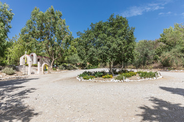 Obraz premium Small chapel and square in front of the Ostrich farm in the Petaloudes Valley, Rhodes, Greece