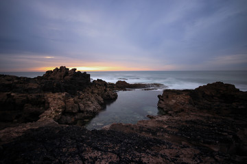 Long exposure in amazing Wild rock beach at the sunset. Sintra Cascais Natural park