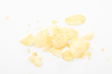 Crispy potato chips and crumbs, on white background.