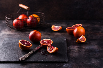 Sicilian oranges on a black slate background.