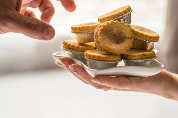 Closeup View Human Hands Take Spicy Christmas Mince Pies From Star Shape Plate