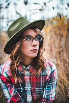  Pretty girl with glasses and hat  closeup portrait outdoors in the green park in autumn