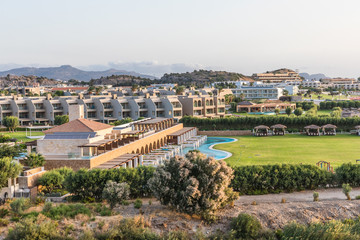 Fototapeta premium Stony landscape of Tsambika mountain and a view of Kolymbia in the early morning, a small resort on the Rhodes Island, Greece. 