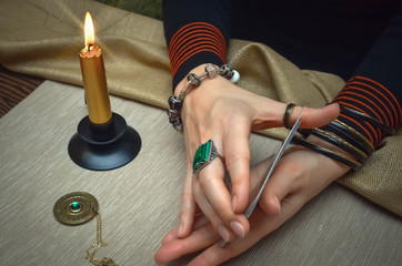 Tarot cards on fortune teller desk table. Future reading. Woman fortune teller holding in hands a...