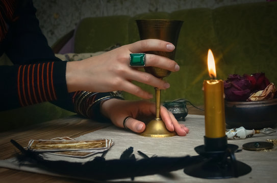Woman witch prepare a magic potion. Future reading. Tarot cards on fortune teller desk table.
