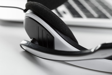 call center support concept. headset on keyboard computer laptop