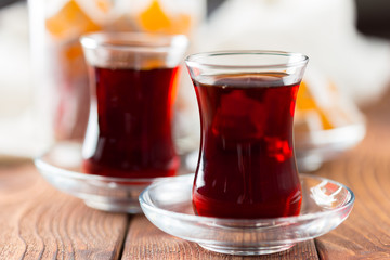 Red tea in turkish glasses on a wooden table
