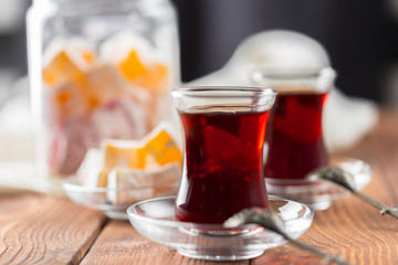 Red tea in turkish glasses on a wooden table