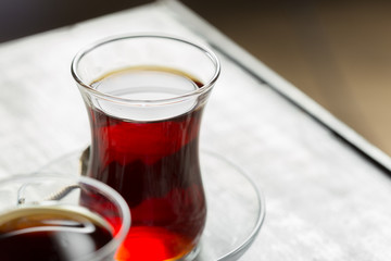 Red tea in turkish glasses on a wooden table