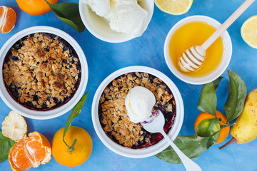 Winter breakfast with berry crumble cake and tea with lemon.