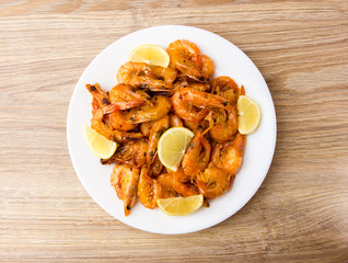 Fried shrimps with lemon. Shrimp fried in a frying pan with butter and garlic.