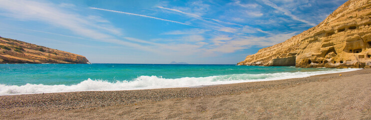 Fototapeta na wymiar Panorama of Matala, beautiful beach on Crete island, waves and rocks.
