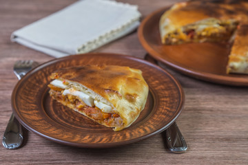 Galician empanada pie in a ceramic dish. The Spanish national dish. Close-up.