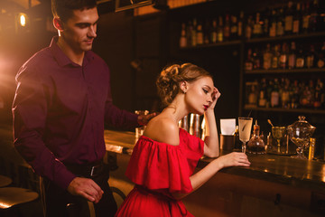Date in nightclub, couple against bar counter