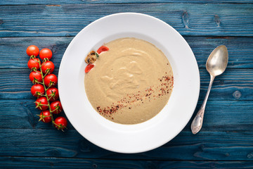 Mushroom puree soup. On a wooden background. Free space for your text. Top view.