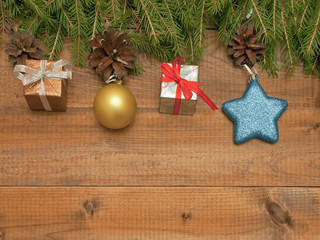 Christmas toys and gifts on wooden background with fir branches