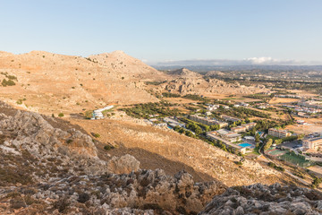 Stony landscape of Tsambika mountain and a view of Kolymbia in the early morning, a small resort on the Rhodes Island, Greece. 