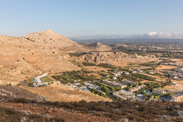 Stony landscape of Tsambika mountain and a view of Kolymbia in the early morning, a small resort on the Rhodes Island, Greece. 