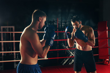 Fototapeta na wymiar Young professional boxers training in ring