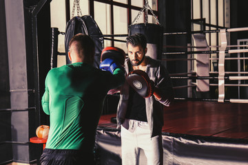 Fototapeta na wymiar Young professional boxers training in gym