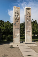 Fototapeta na wymiar Stone cross in Echmiadzin (Vagharshapat) made of red stone tufa. ,