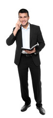 Male manager with notebook talking on mobile phone against white background