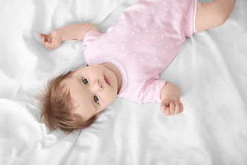 Fototapeta na wymiar Cute little baby lying on bed at home