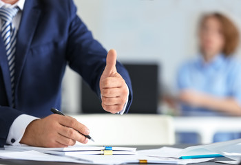 Businessman signing documents in office