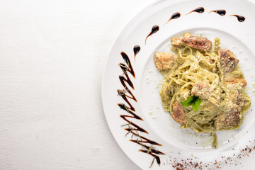 Pasta with white mushrooms and cream sauce. Tagliateli Italian cuisine. Free space for your text. Top view.