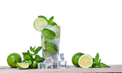 Mojito cocktail with fresh lime, mint leaves and ice cubes in a transparent glass on a wooden background. Refreshing alcohol drink. Isolated on white background.