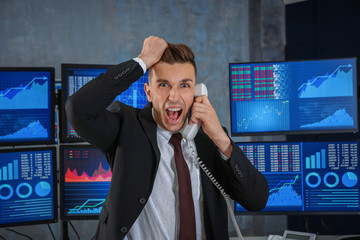 Male stock trader working in office