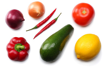 healthy food. mix of avocado, lemon, tomato, red onion, garlic, sweet bell pepper and rucola leaves isolated on white background top view