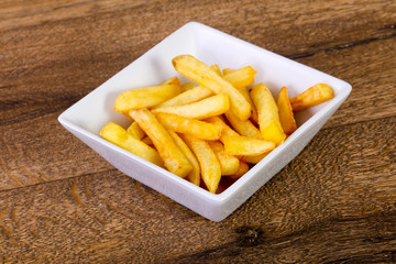 French potato over wooden background