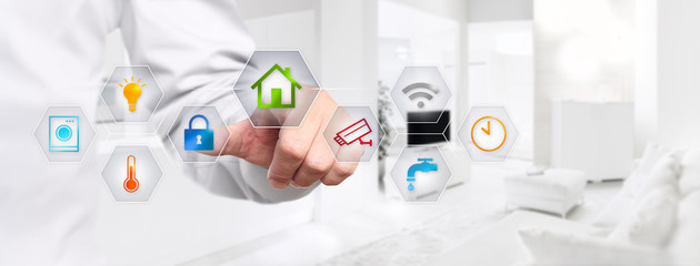 Fototapeta premium smart home automation hand touch screen with colored symbols on interior room background web banner and copy space template