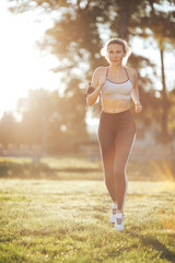 Young woman running during sunny morning