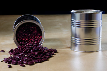 Delicious beans in a metal jar on a wooden kitchen table.
