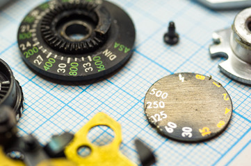 parts old retro film SLR camera on graph paper