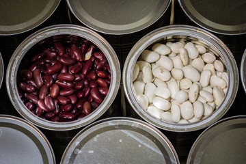 Delicious beans in a metal jar on a wooden kitchen table.