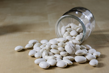 Delicious bean in a glass jar on a wooden kitchen table.