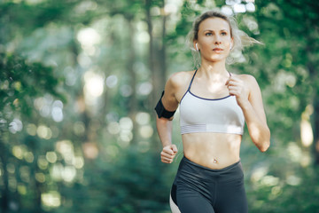 Fitness woman running in the morning park