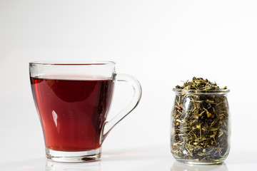Tea in a glass on a white background. Green or fruit tea.